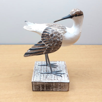 Hand Carved and Painted Decorative Godwit bird figurine on a wooden base against a plain background