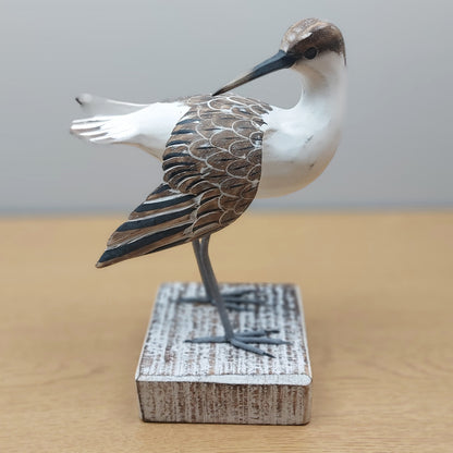 Handmade Godwit Bird figurine made in Bali on a wooden base with a plain background