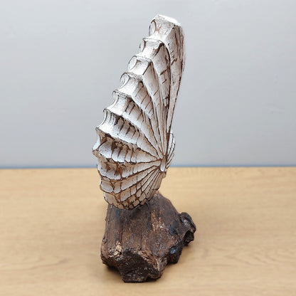Decorative wooden White shell sculpture on a wooden base with a plain background