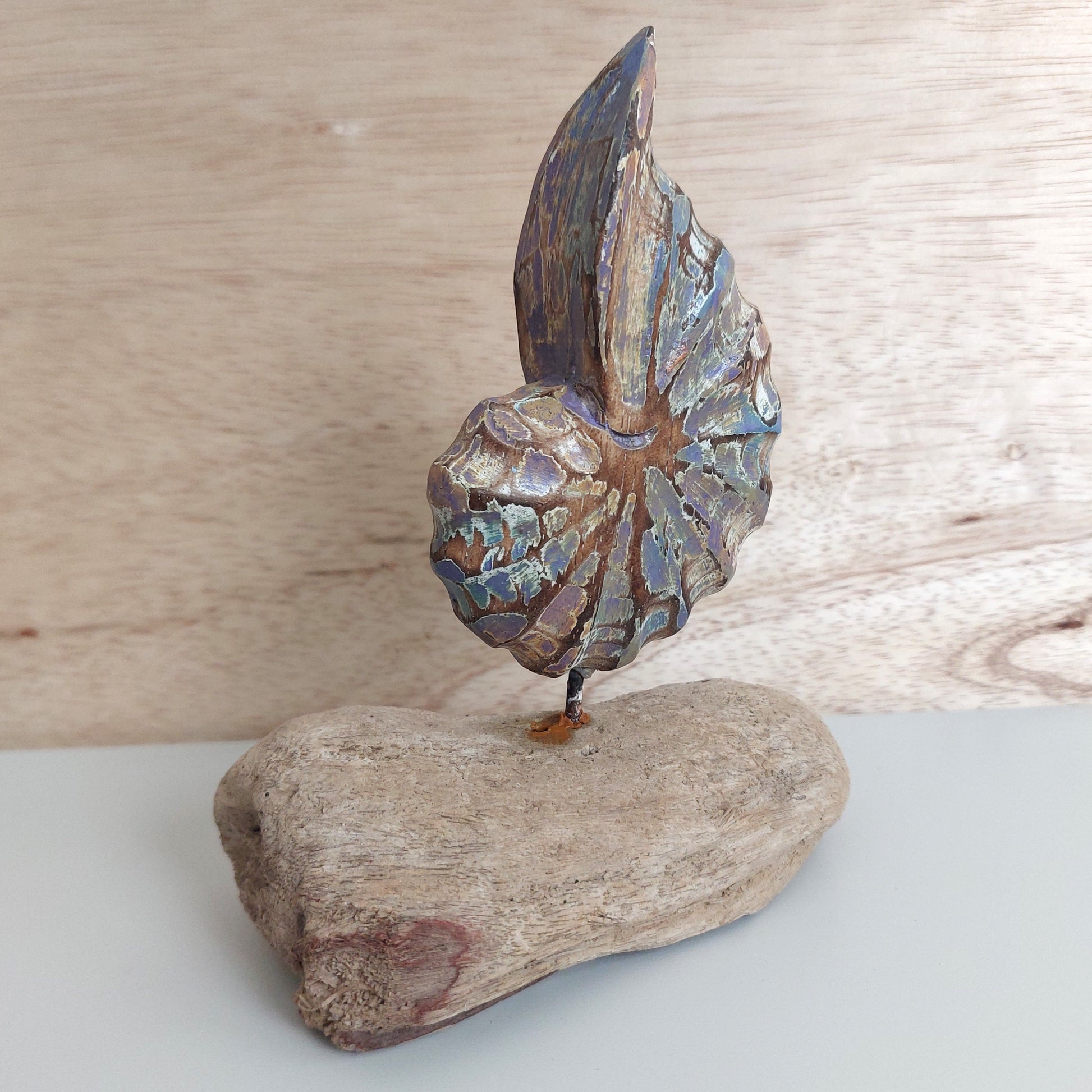Decorative wooden shell made in Bali on a wooden base against a wooden background
