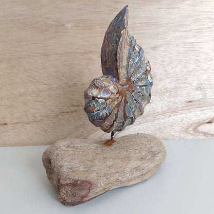 Decorative wooden shell made in Bali on a wooden base against a wooden background