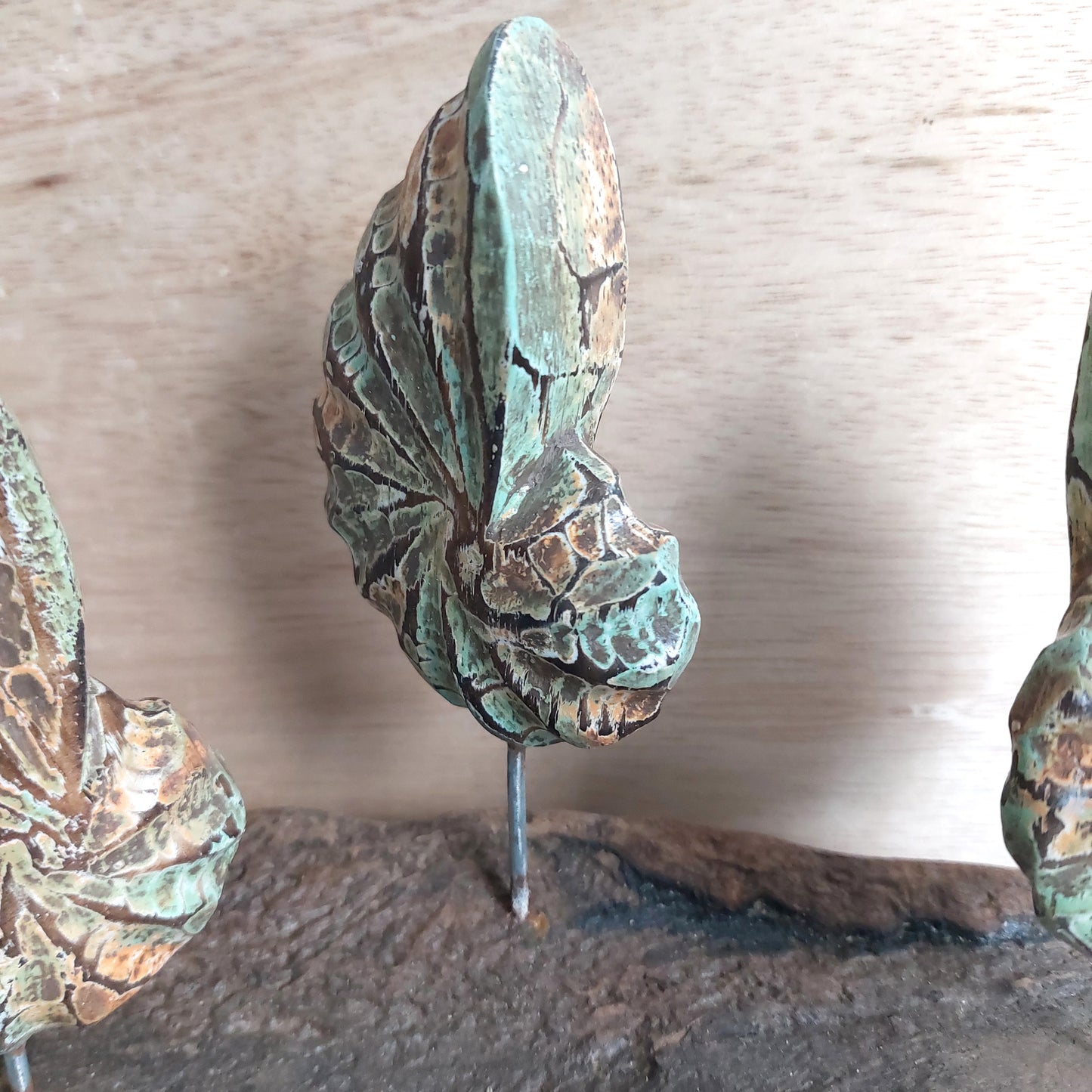 Green and Brown wooden shell figurine decorative item on a wooden surface