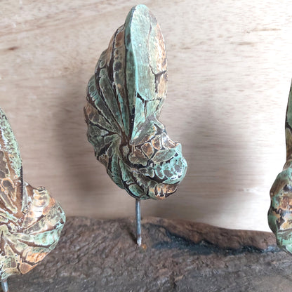 Green and Brown wooden shell figurine decorative item on a wooden surface