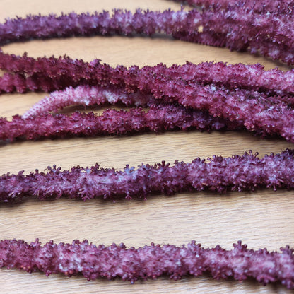 Close up of purple fake amaranthus flower spikes, ideal for home décor, weddings and events
